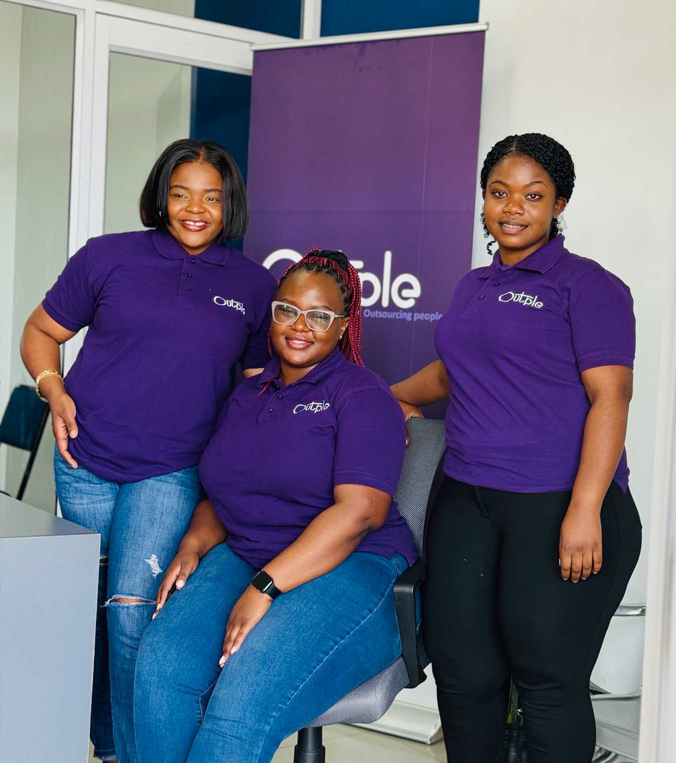 Outple team members in branded purple shirts